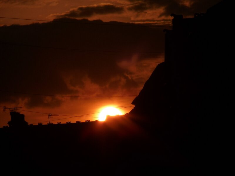 Sun Setting Behind Buildings — Orange, Dramatic, Sunset