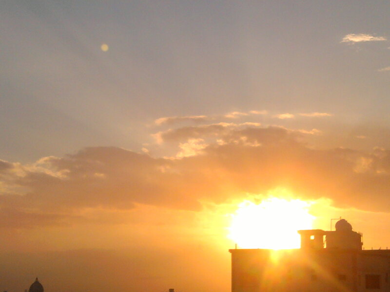 Sun Setting Behind Buildings
