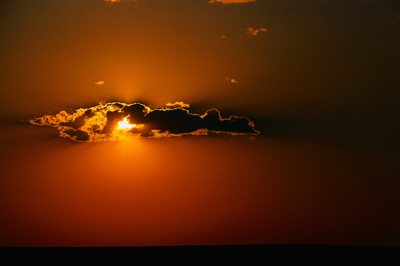 Sun Setting Behind Cloud — Orange