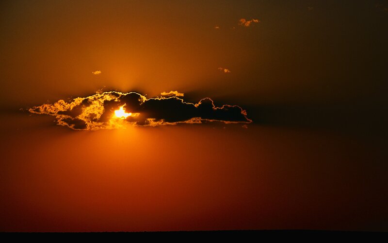 Sun Setting Behind Cloud