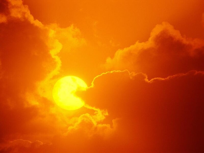 Sun setting behind clouds