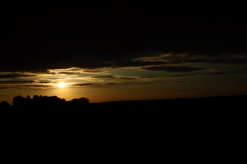 Sun Setting Behind Clouds — Black, Dramatic
