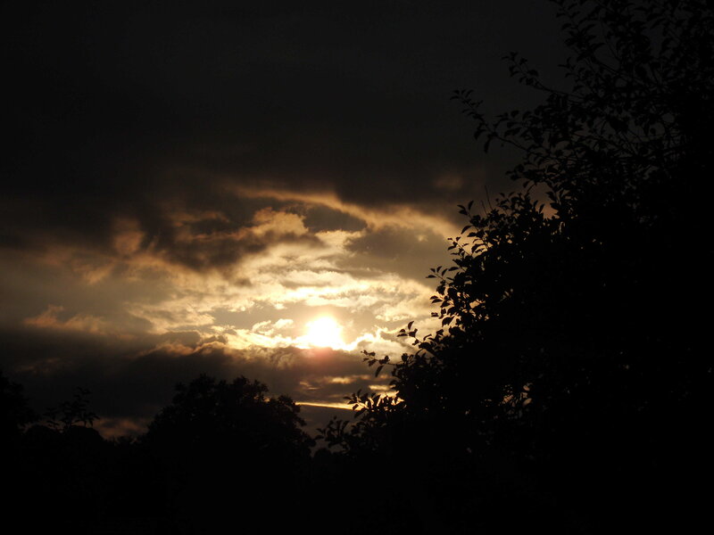 Sun Setting Behind Clouds — Black