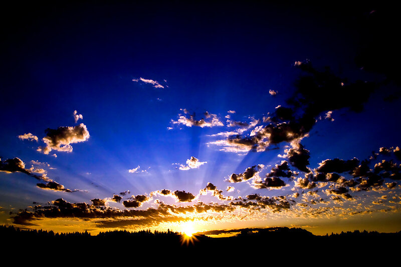 Sun Setting Behind Clouds — Blue, Dramatic, Sunset, Photograph, Sky, Trees