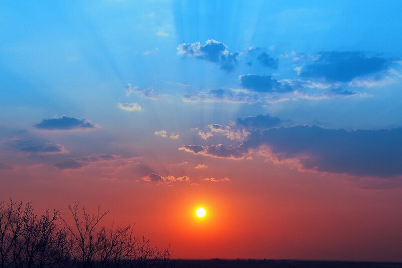 Sun Setting Behind Clouds — Blue, Dramatic, Sunset, Photograph, Trees