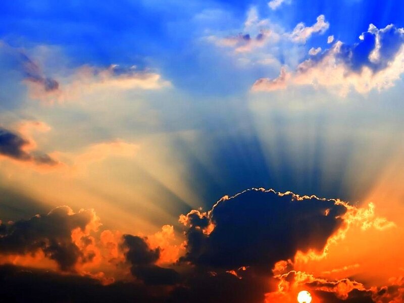 Sun Setting Behind Clouds — Blue, Dramatic, Sunset