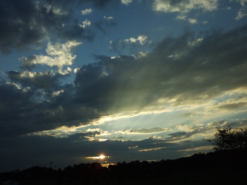Sun Setting Behind Clouds — Blue, Dramatic