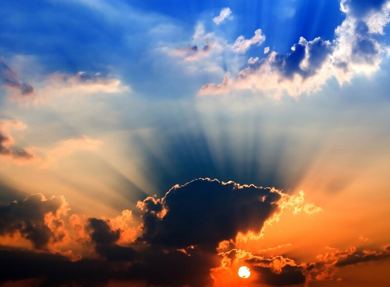 Sun Setting Behind Clouds — Blue, Orange