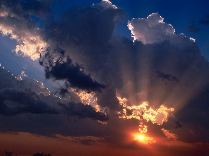 Sun Setting Behind Clouds — Blue, Photograph