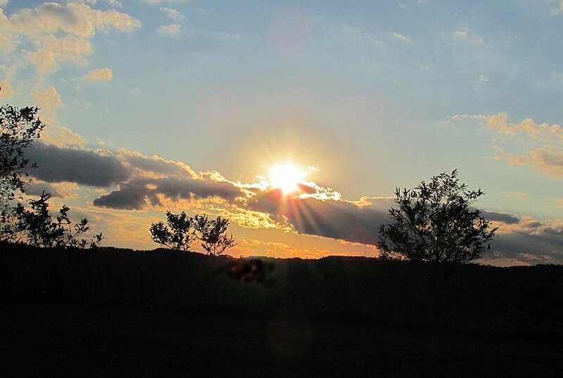 Sun Setting Behind Clouds — Blue, Serene, Sunset