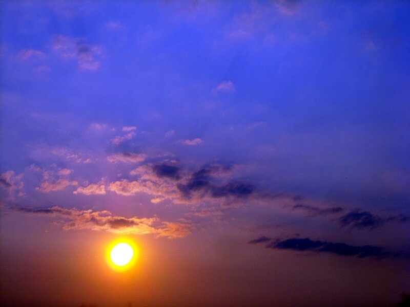 Sun Setting Behind Clouds — Blue, Serene