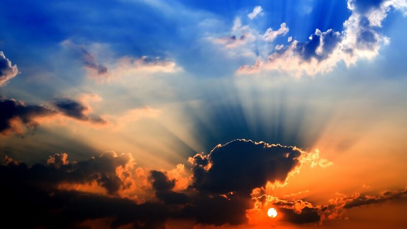 Sun Setting Behind Clouds — Blue, Sunset