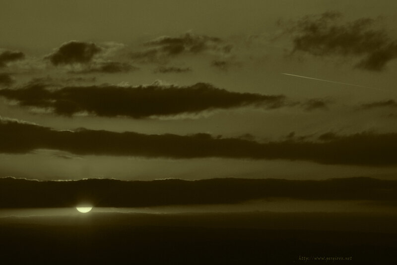 Sun Setting Behind Clouds — Brown