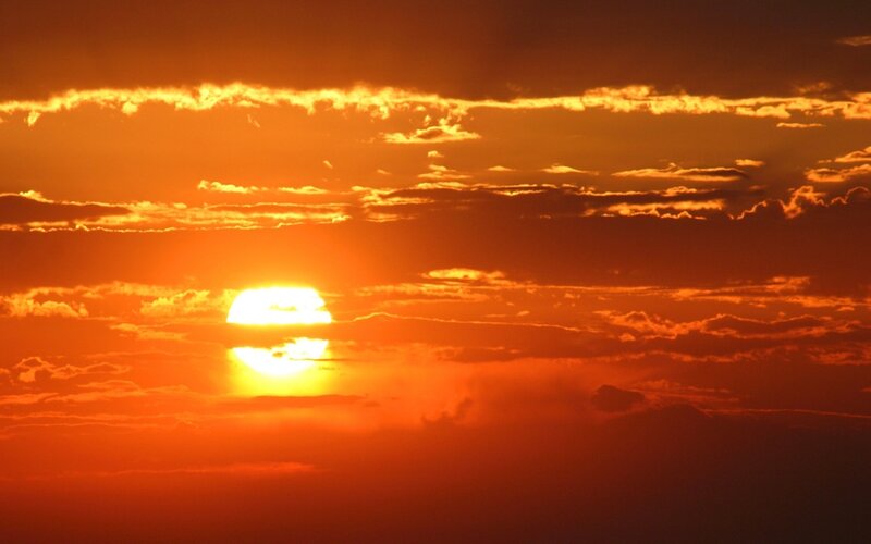Sun Setting Behind Clouds — Dramatic, Sunset