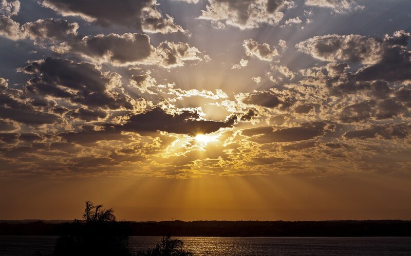 Sun Setting Behind Clouds — Gold, Dramatic, Sunset, Photograph