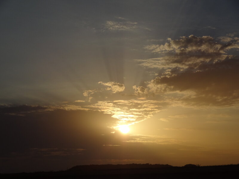 Sun Setting Behind Clouds — Gold, Dramatic