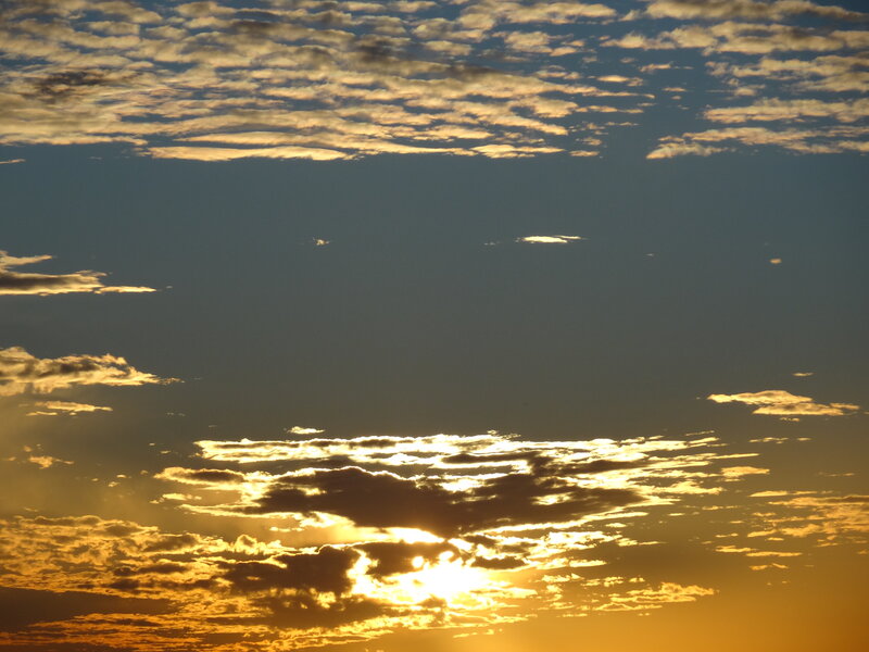 Sun Setting Behind Clouds — Gold