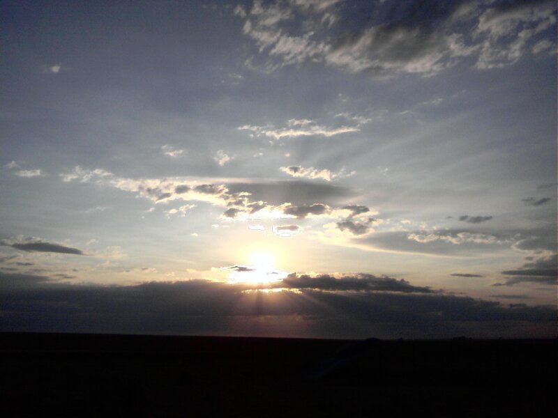 Sun Setting Behind Clouds — Gray, Dramatic