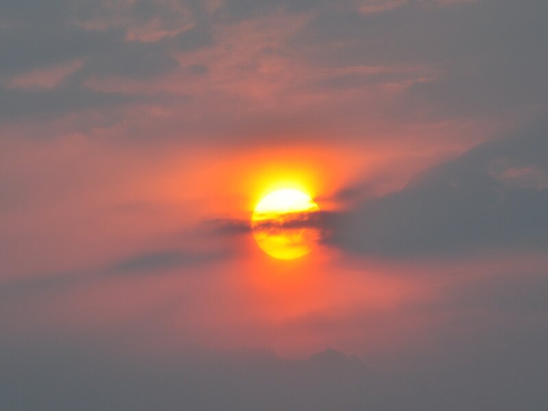 Sun Setting Behind Clouds — Gray