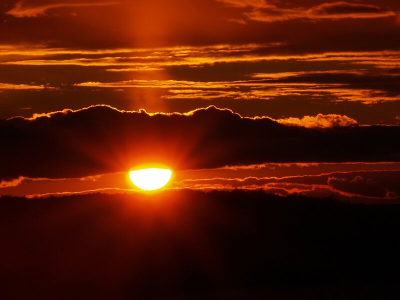Sun Setting Behind Clouds — Horizon
