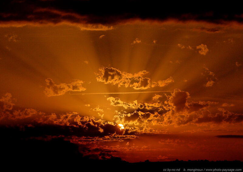 Sun Setting Behind Clouds — Orange, Dramatic, Sunset, Photograph, Contrail
