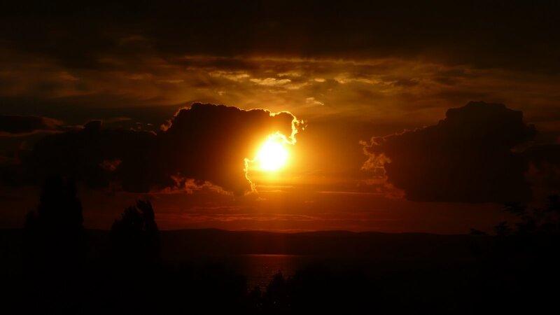 Sun Setting Behind Clouds — Orange, Dramatic, Sunset, Photograph, Mountains