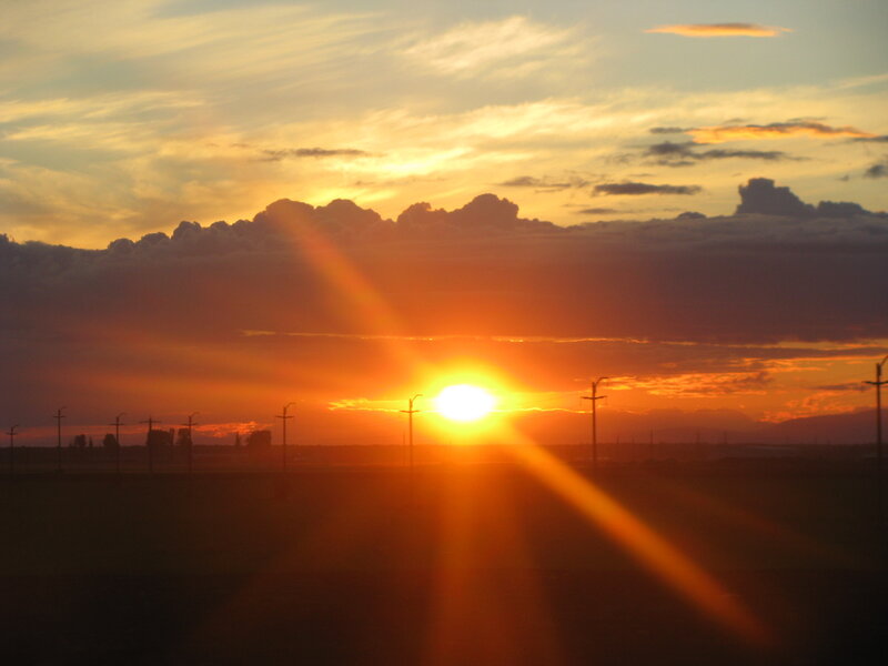 Sun Setting Behind Clouds — Orange, Dramatic, Sunset, Photograph, Power Lines, Field