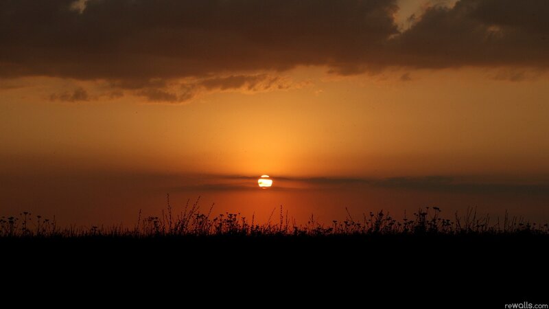 Sun Setting Behind Clouds — Orange, Dramatic, Sunset, Photograph, Sky, Grass, Black