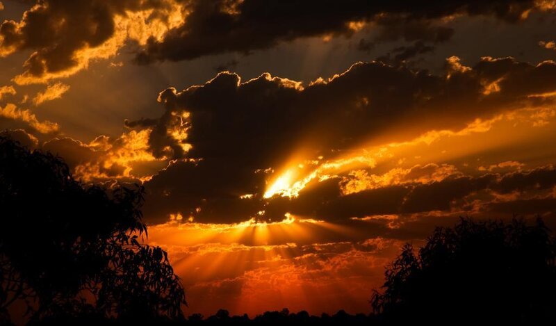 Sun Setting Behind Clouds — Orange, Dramatic, Sunset, Photograph, Trees, Sunbeams