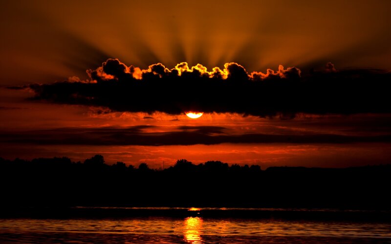 Sun Setting Behind Clouds — Orange, Dramatic, Sunset, Photograph, Water