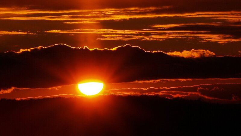 Sun Setting Behind Clouds — Orange, Photograph