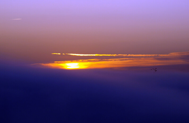 Sun Setting Behind Clouds — Purple