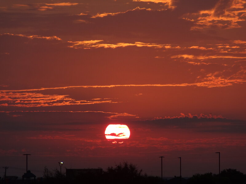Sun Setting Behind Clouds — Red, Dramatic, Sunset, Photograph, Silhouettes
