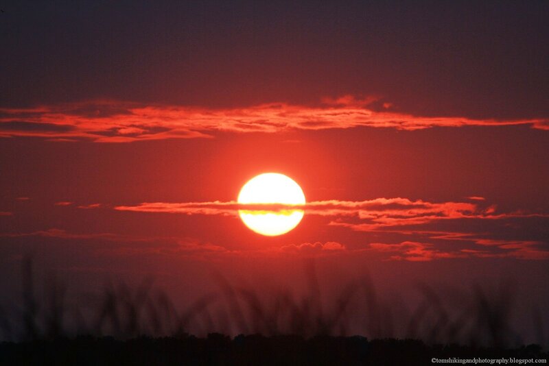 Sun Setting Behind Clouds — Red, Dramatic