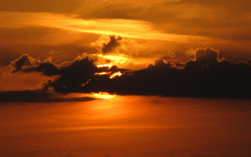 Sun Setting Behind Clouds — Sunset, Black