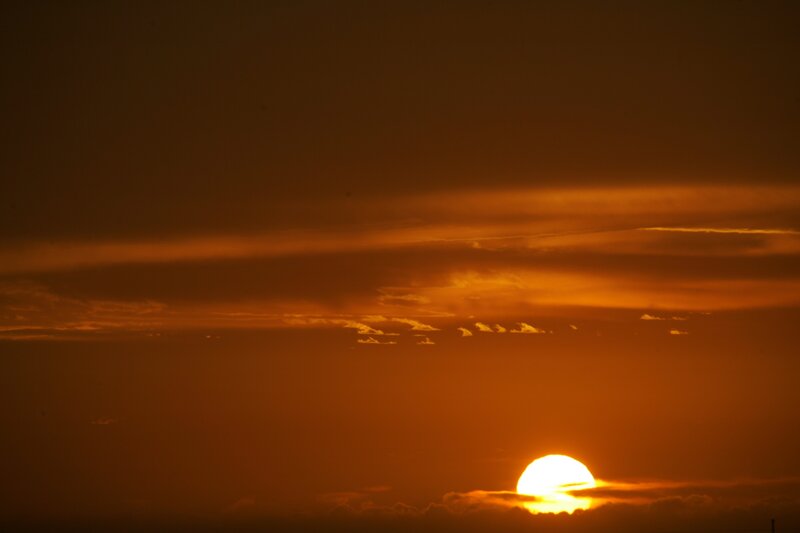 Sun Setting Behind Clouds — Sunset, Photograph