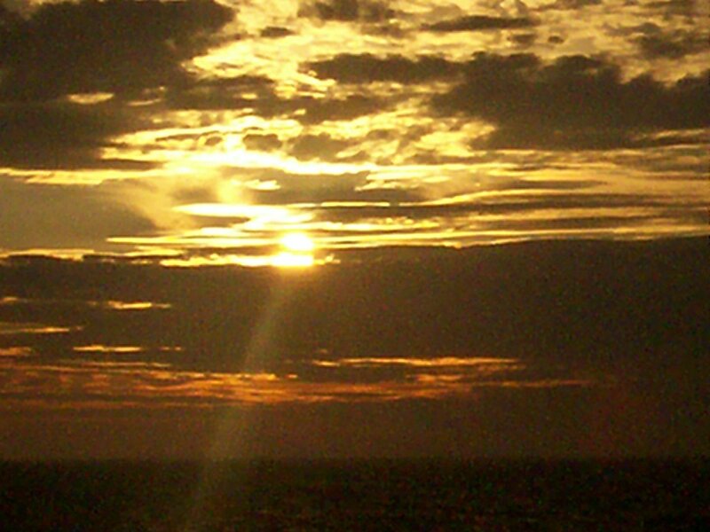 Sun Setting Behind Clouds — Yellow, Dramatic, Sunset, Photograph, Sky, Horizon, Orange