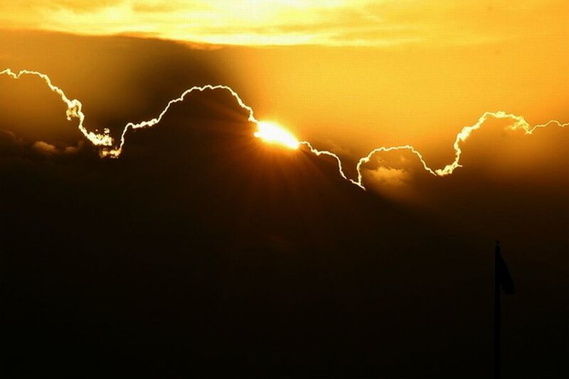 Sun Setting Behind Clouds — Yellow, Dramatic