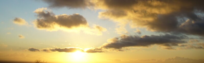 Sun Setting Behind Clouds — Yellow, Serene, Sunset