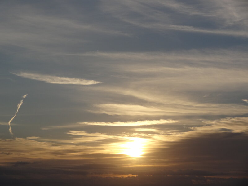 Sun Setting Behind Clouds — Yellow, Serene