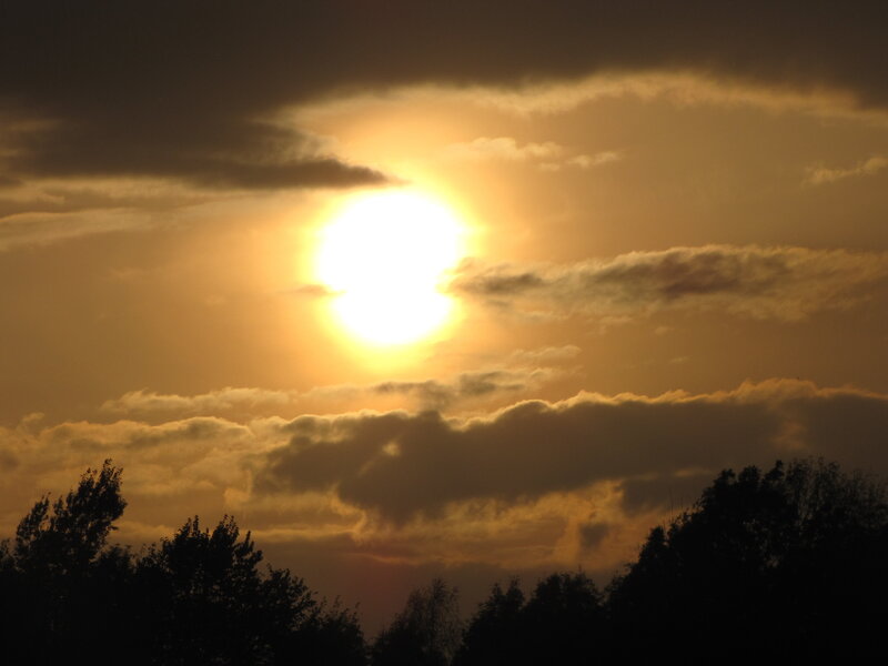 Sun Setting Behind Clouds — Yellow
