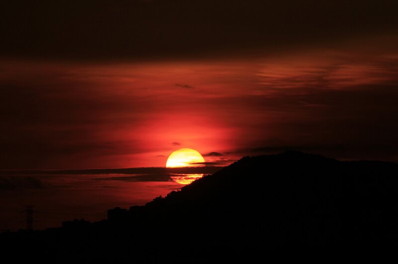 Sun Setting Behind Hill