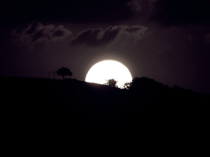 Sun Setting Behind Hills — Black, Dramatic