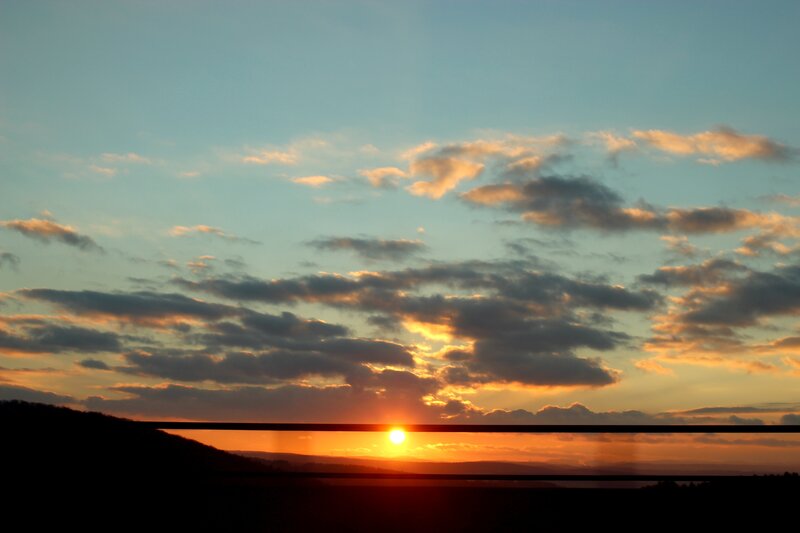 Sun Setting Behind Hills — Orange, Serene, Sunset, Photograph, Clouds, Horizon, Silhouette, Blue