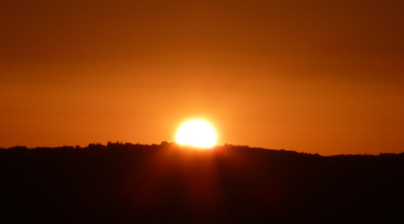 Sun Setting Behind Hills — Orange, Serene