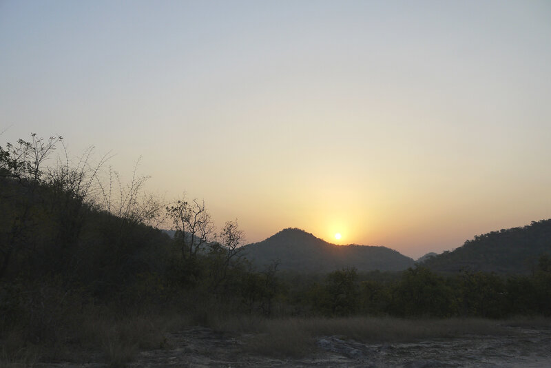 Sun Setting Behind Hills — Orange