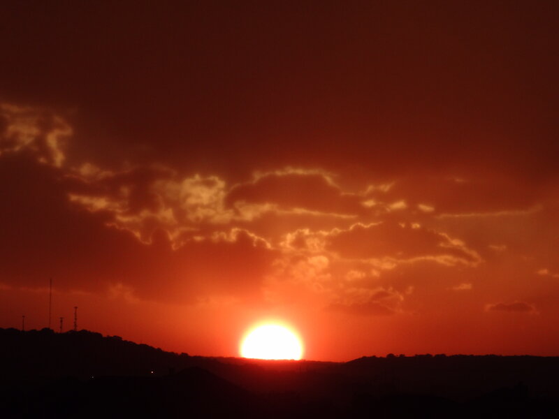 Sun Setting Behind Hills — Red, Dramatic