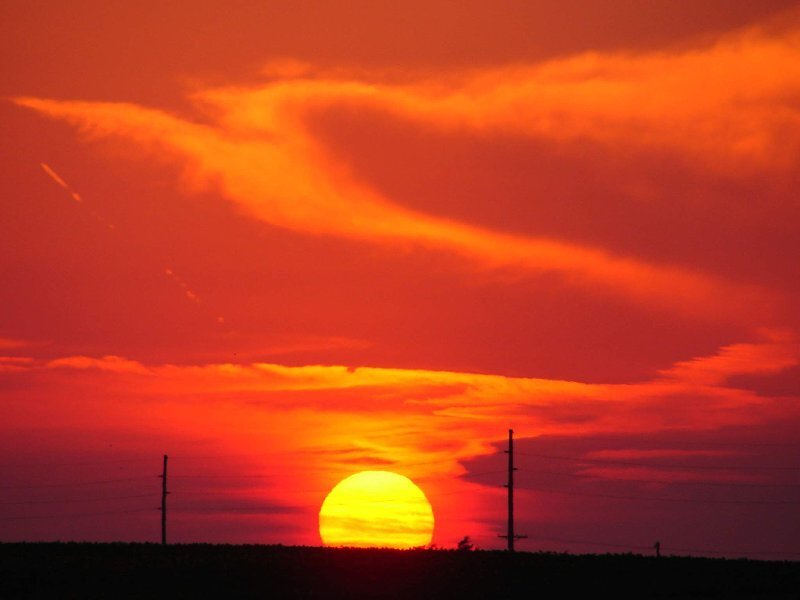 Sun Setting Behind Hills — Red