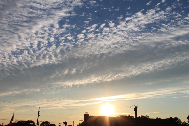 Sun Setting Behind Houses — Blue