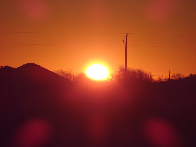 Sun Setting Behind Houses — Orange, Dramatic
